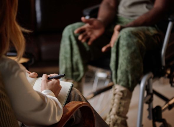 war-veteran-in-wheelchair-talking-to-therapist-at-2025-02-11-15-37-14-utc